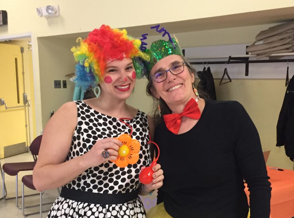 Two Machar members dressed up for Purim. One is dressed as a clown, the other as a queen bee.